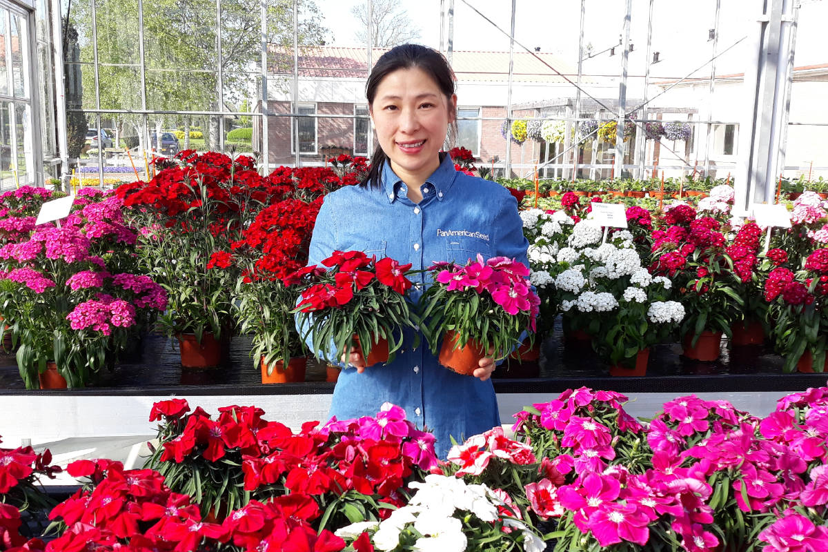one of our plant breeders holding plants