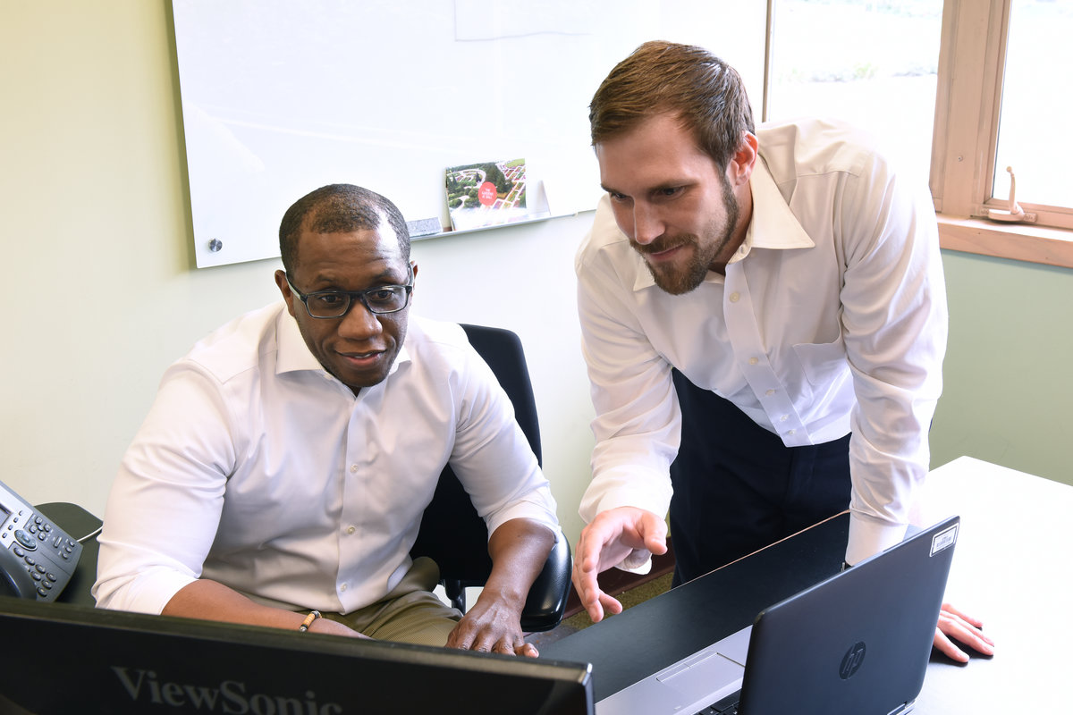 finance managers looking at computer