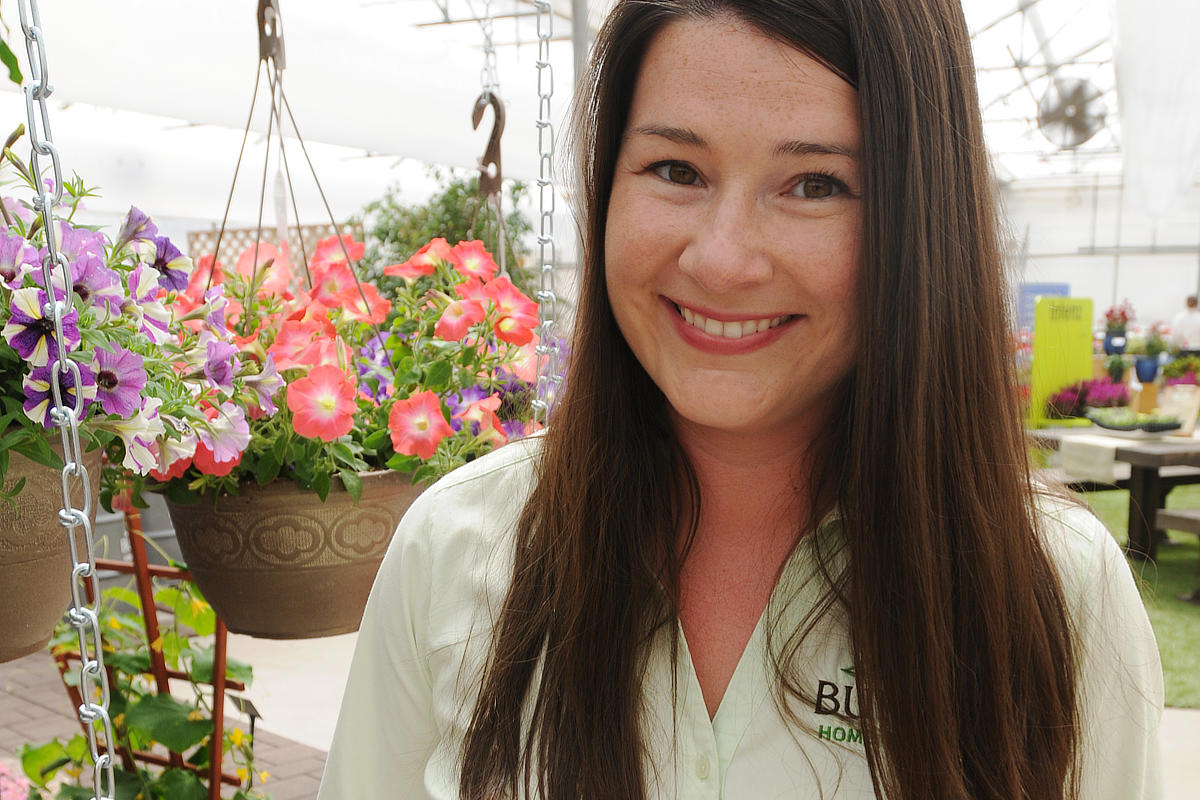 sales rep stading next to hanging basket